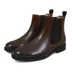 We showcase the Brown Daniele Chelsea Boot in a 3/4 front Pair view with full-grain leather and sleek stitching – Devogue Paris