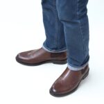 Side view of Vittoriio Wingtip Chelsea Boots wearing by a model